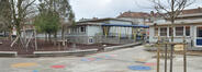 École Van Asbroeck, vue d’ensemble des façades arrière de l’école maternelle avec passage couvert entre les deux pavillons, 2023