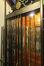 Rue Mercelis 63. Cabine avec grille rétractile fermée et détail de la porte palière © Homegrade , 2022